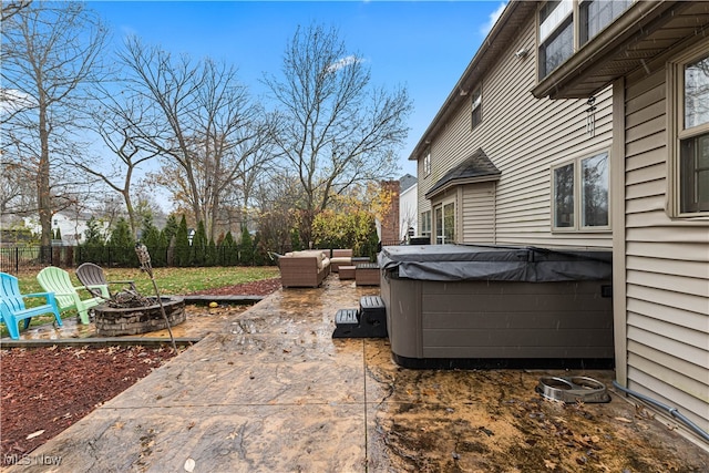 view of patio featuring an outdoor living space with a fire pit