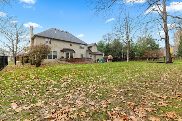 back of property with a yard and a trampoline