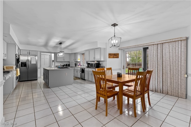 tiled dining space with an inviting chandelier