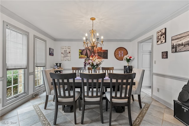 dining room featuring a notable chandelier, light tile patterned floors, and crown molding