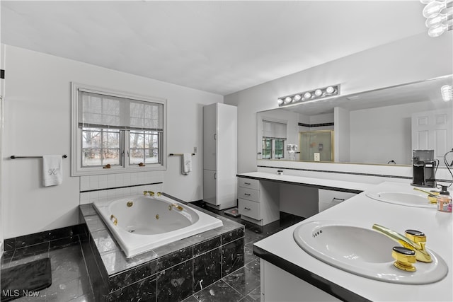 bathroom with vanity and a relaxing tiled tub