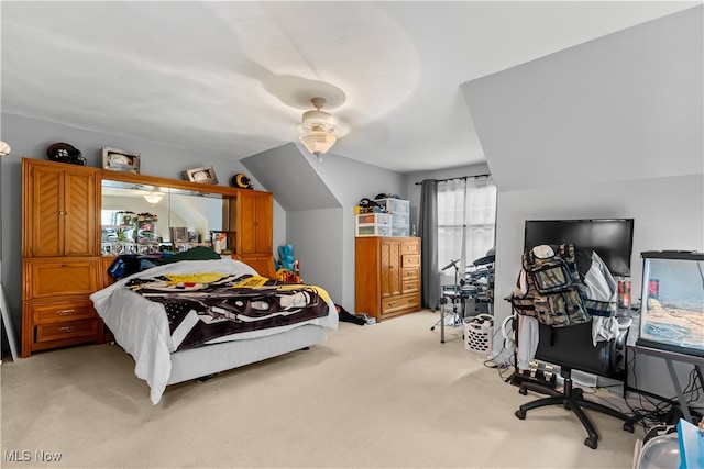 bedroom featuring ceiling fan, lofted ceiling, and light carpet