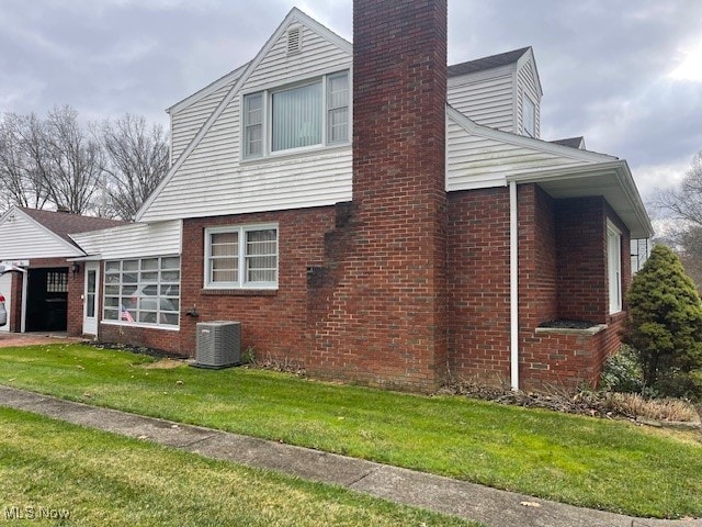 view of property exterior featuring cooling unit and a lawn