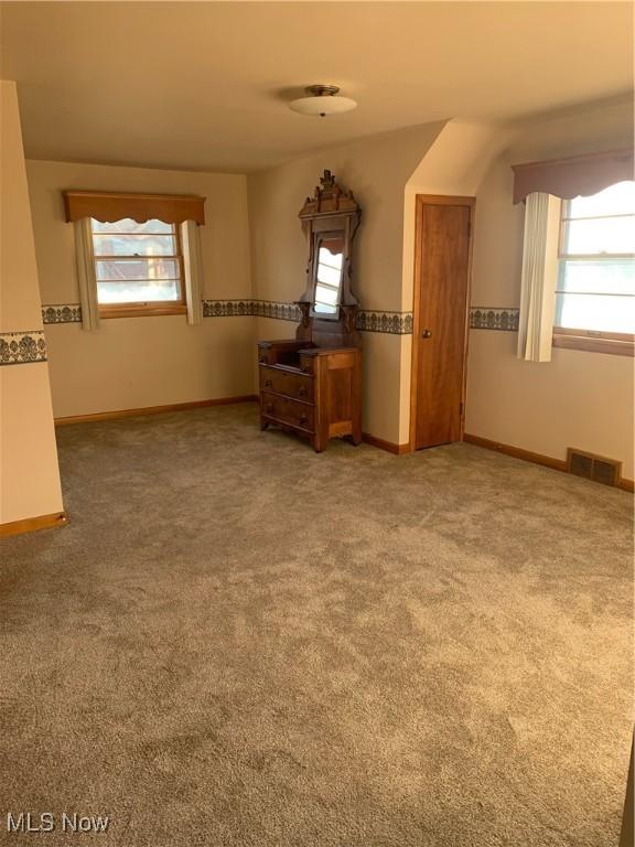 unfurnished room featuring carpet flooring