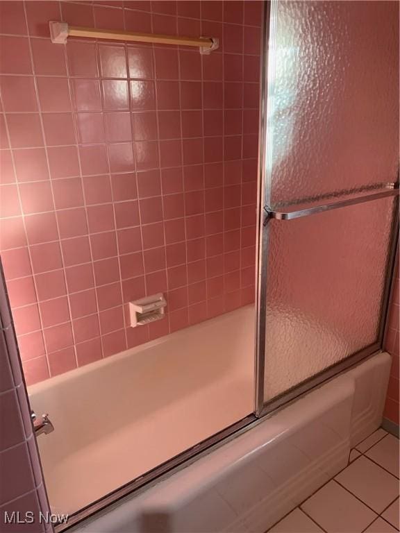 bathroom featuring tiled shower / bath combo and tile patterned floors