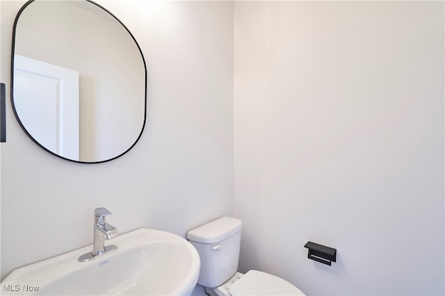 half bathroom with a sink and toilet