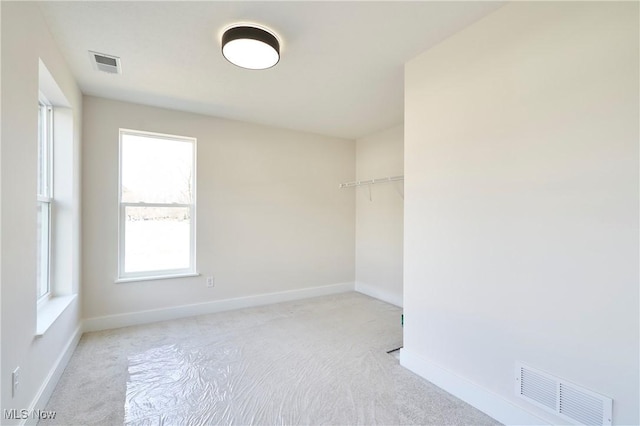 empty room with carpet floors and baseboards