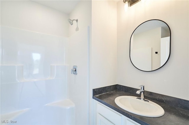 bathroom with a shower and vanity