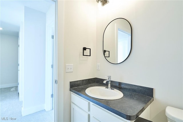 bathroom with toilet and vanity