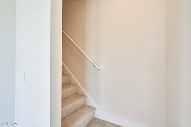 stairs with carpet flooring and baseboards