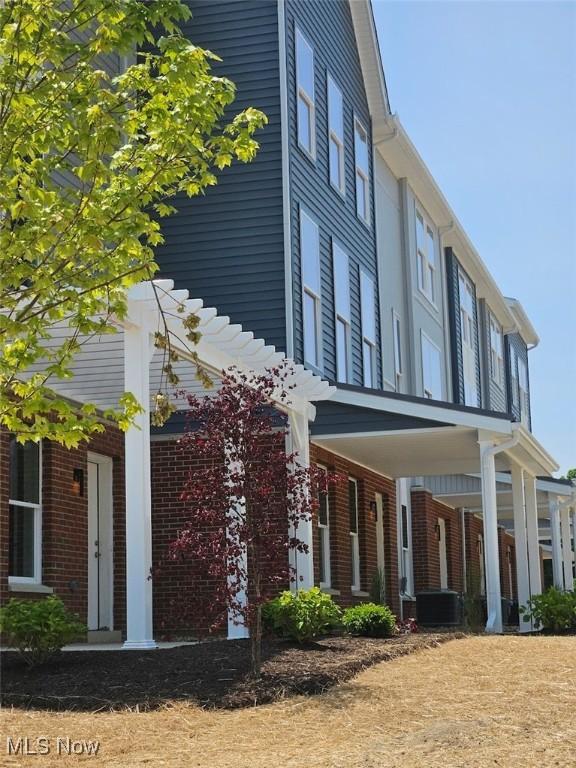 596 Mull Ave Unit 8, Akron, OH 44313 - view of property exterior featuring brick siding and a porch
