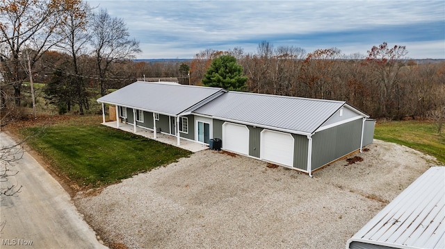 view of front of house featuring a front yard, a porch, and a garage