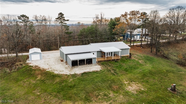 back of house with a garage and an outdoor structure