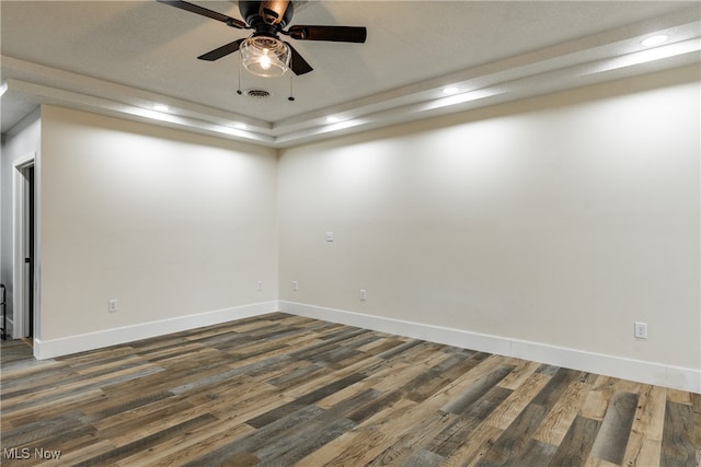 spare room featuring dark hardwood / wood-style floors and ceiling fan