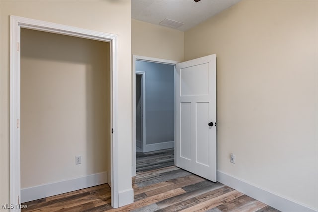 unfurnished bedroom featuring hardwood / wood-style flooring