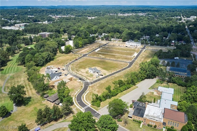 drone / aerial view featuring a wooded view