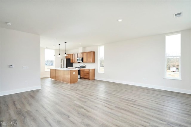 unfurnished living room featuring light wood-style flooring, recessed lighting, baseboards, and visible vents