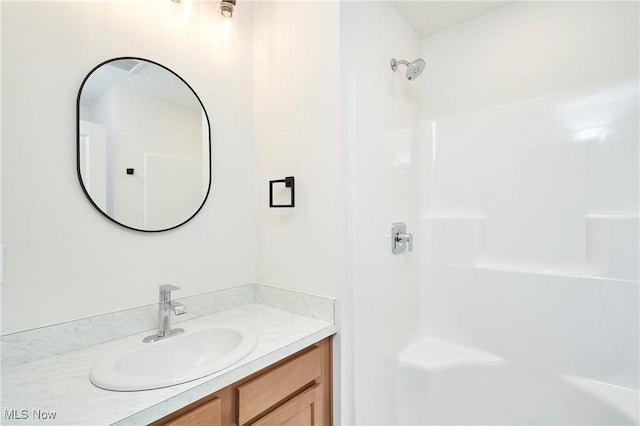 full bathroom featuring vanity and walk in shower