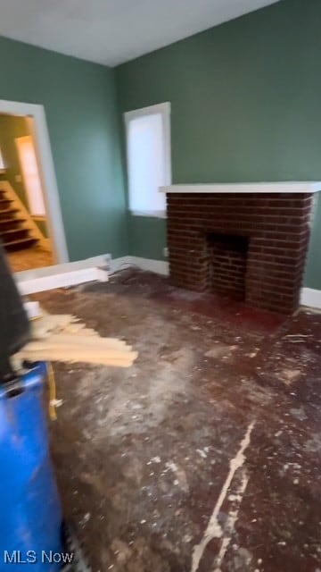 unfurnished living room featuring a brick fireplace