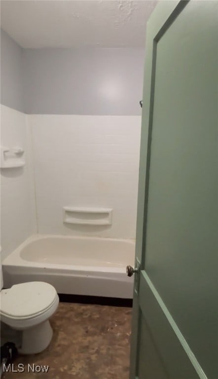 bathroom featuring washtub / shower combination and toilet