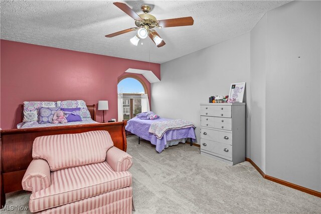 bedroom with light carpet, a textured ceiling, and ceiling fan