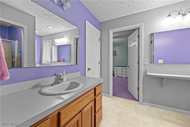 bathroom with vanity and a textured ceiling