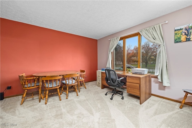 office space featuring light colored carpet and a textured ceiling