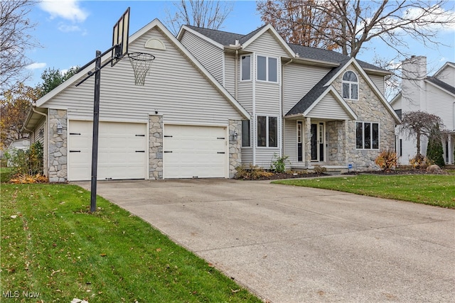 view of front of property with a garage and a front lawn