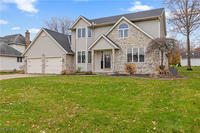 view of front of property with a front yard and a garage