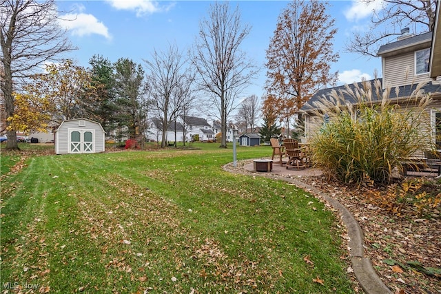 view of yard featuring a storage shed and a patio