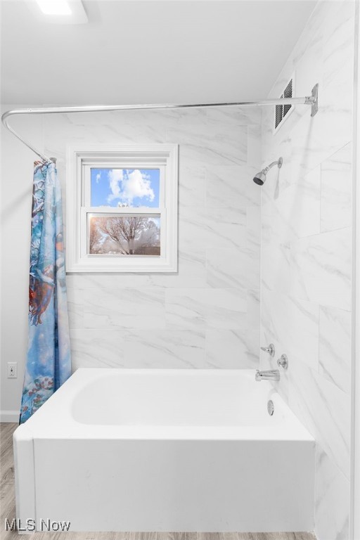 bathroom featuring shower / bath combination with curtain and wood-type flooring