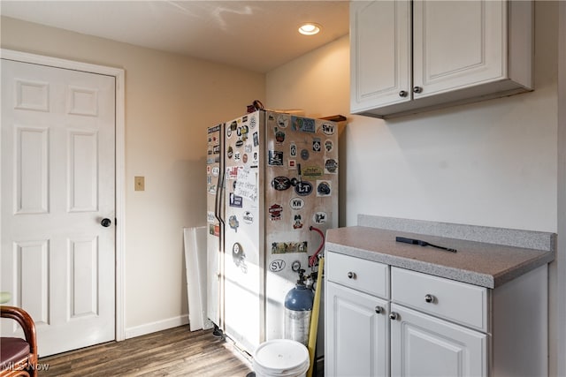 kitchen featuring dark hardwood / wood-style floors and white cabinetry