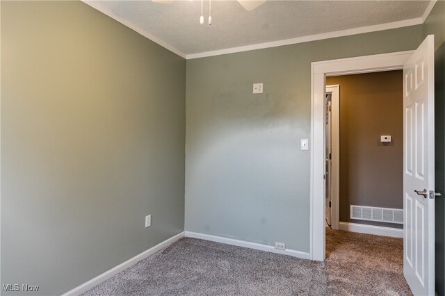 spare room with light carpet and a textured ceiling