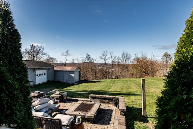 view of yard featuring a patio area, an outdoor structure, and a garage