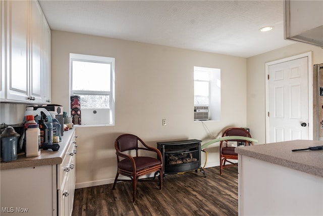 living area featuring cooling unit and dark hardwood / wood-style floors