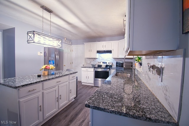 kitchen featuring white cabinetry, stainless steel appliances, dark hardwood / wood-style floors, pendant lighting, and a kitchen island