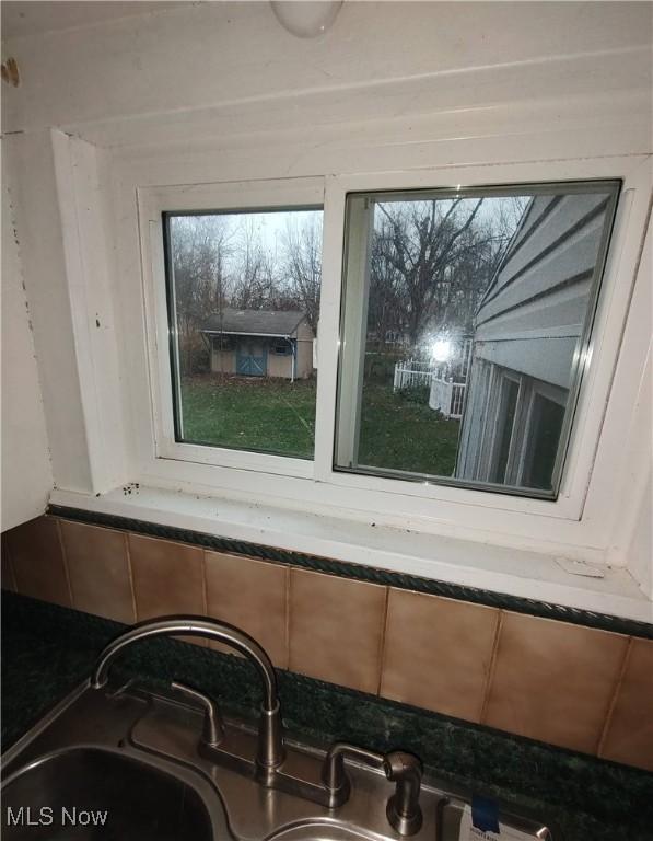 interior details featuring dark stone countertops and sink