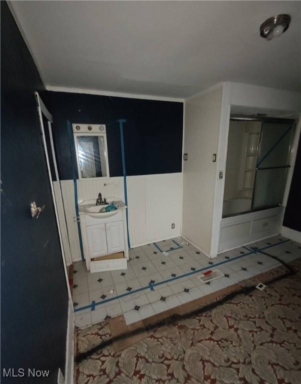 interior space with vanity and bathing tub / shower combination