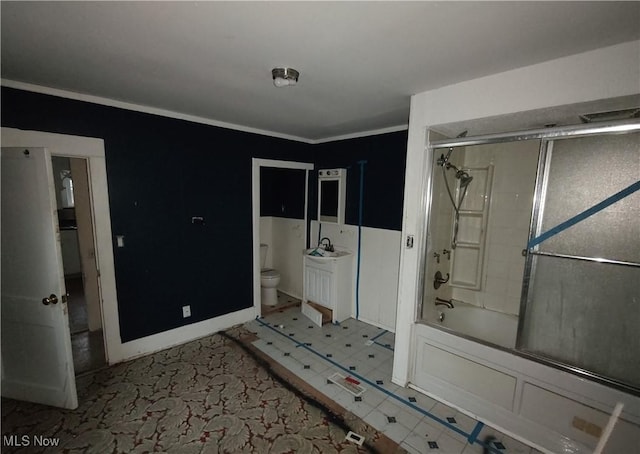 full bathroom with crown molding, sink, combined bath / shower with glass door, and toilet