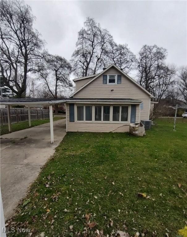 view of home's exterior featuring a lawn and a carport