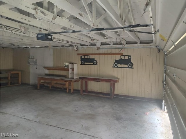 garage with wooden walls and a garage door opener