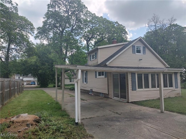 rear view of property featuring a yard