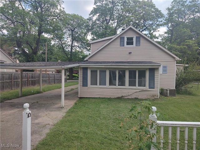 view of property exterior featuring a lawn, central AC unit, and a carport