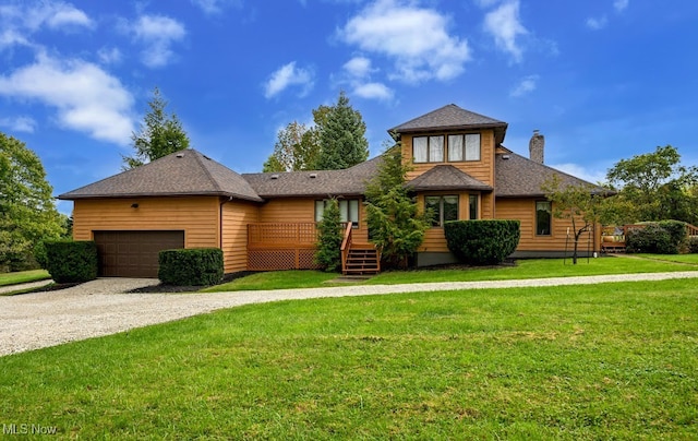 view of front facade with a front yard and a garage