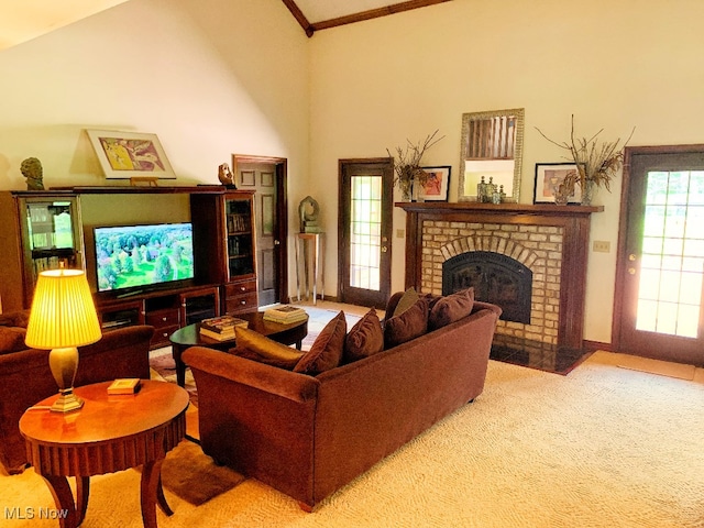 carpeted living room with crown molding, a fireplace, and high vaulted ceiling