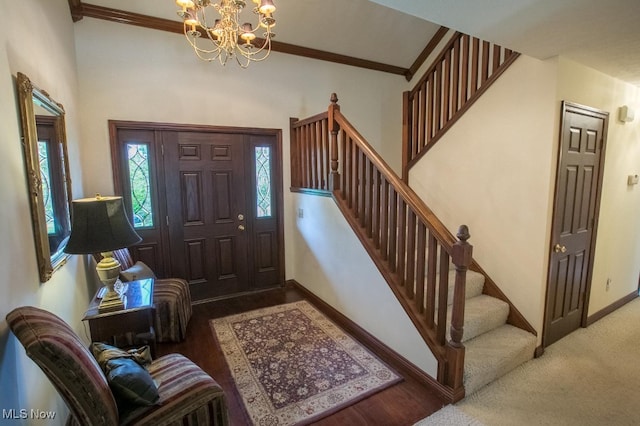 entrance foyer featuring hardwood / wood-style flooring, crown molding, and a notable chandelier