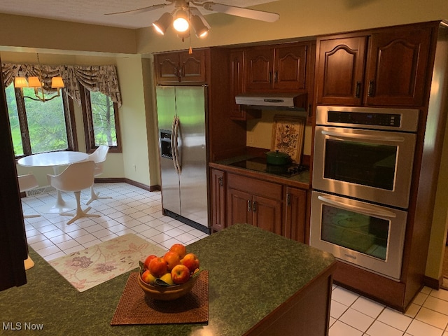 kitchen featuring appliances with stainless steel finishes, ceiling fan with notable chandelier, and light tile patterned floors