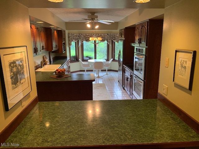 kitchen featuring ceiling fan, light tile patterned floors, fridge, and sink