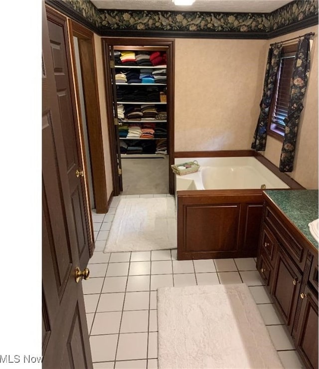 bathroom with vanity, a tub to relax in, and tile patterned floors