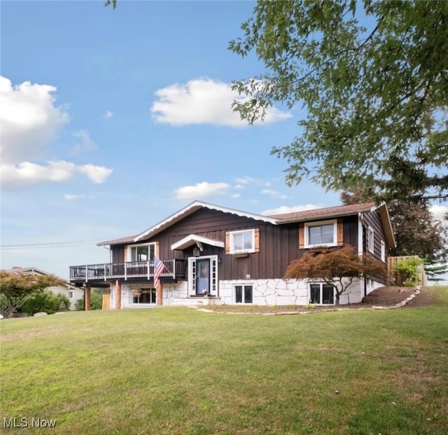 view of front of property featuring a front lawn and a deck